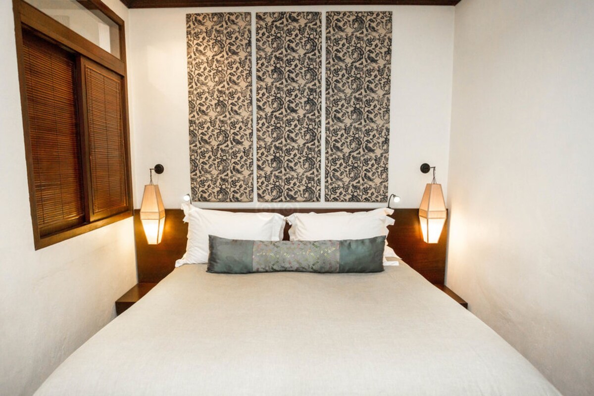 Spacious guest room with timber details and a double bed